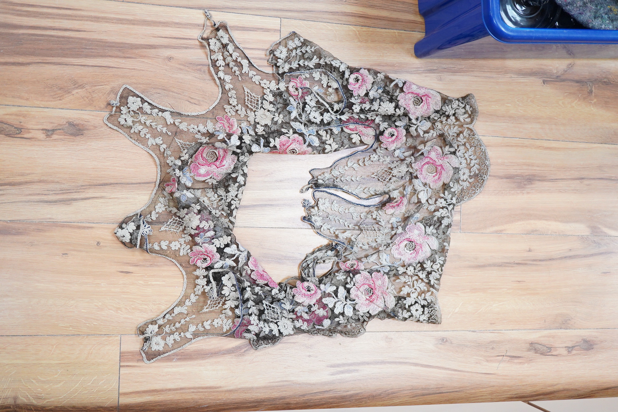 A collection of lace including black and coloured lace panels, mostly machine lace